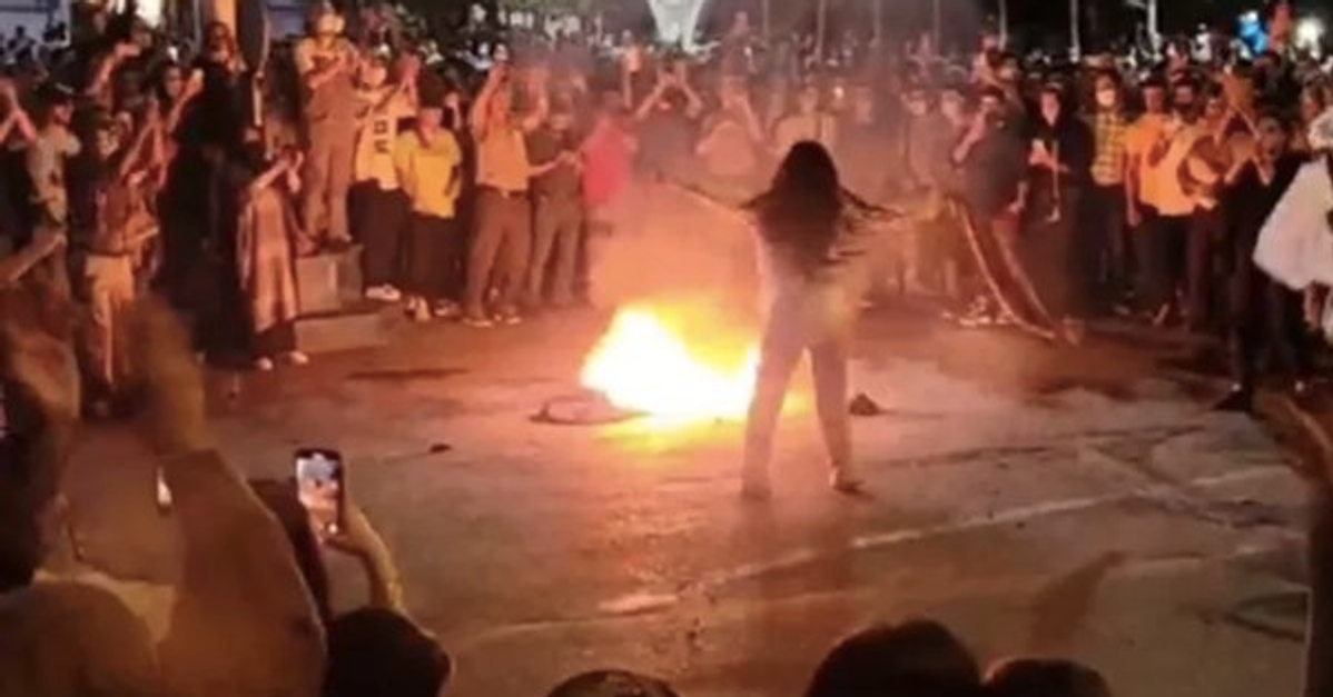 woman who is burning her scarf